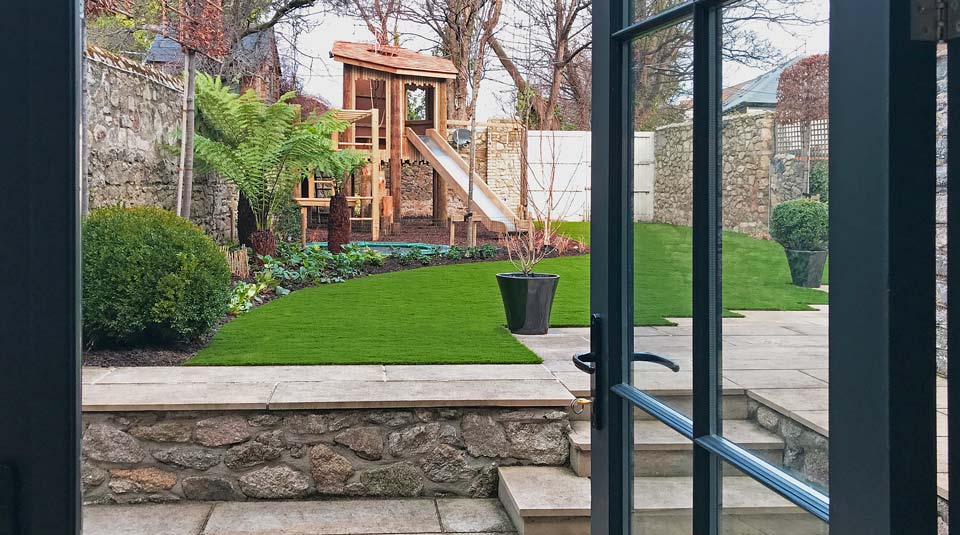 Framed view with bespoke children’s treehouse design by Forest Wild Treehouses.