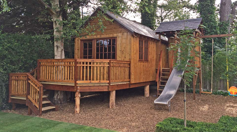 Bespoke classic games room treehouse with slide tower and double swing set