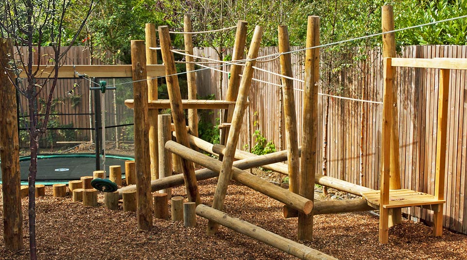 Climbing wall and zipline tower in a Dublin play garden