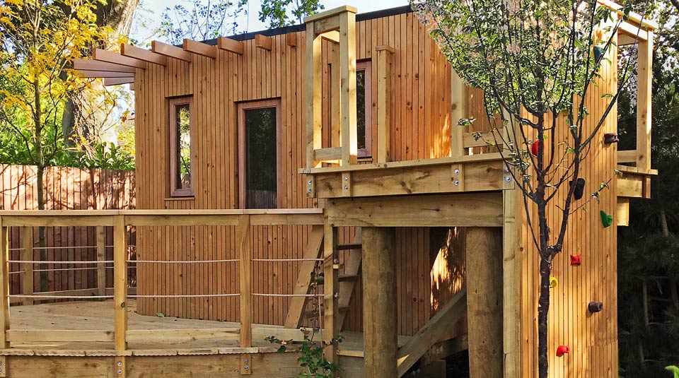 Climbing wall and zipline tower in a Dublin play garden